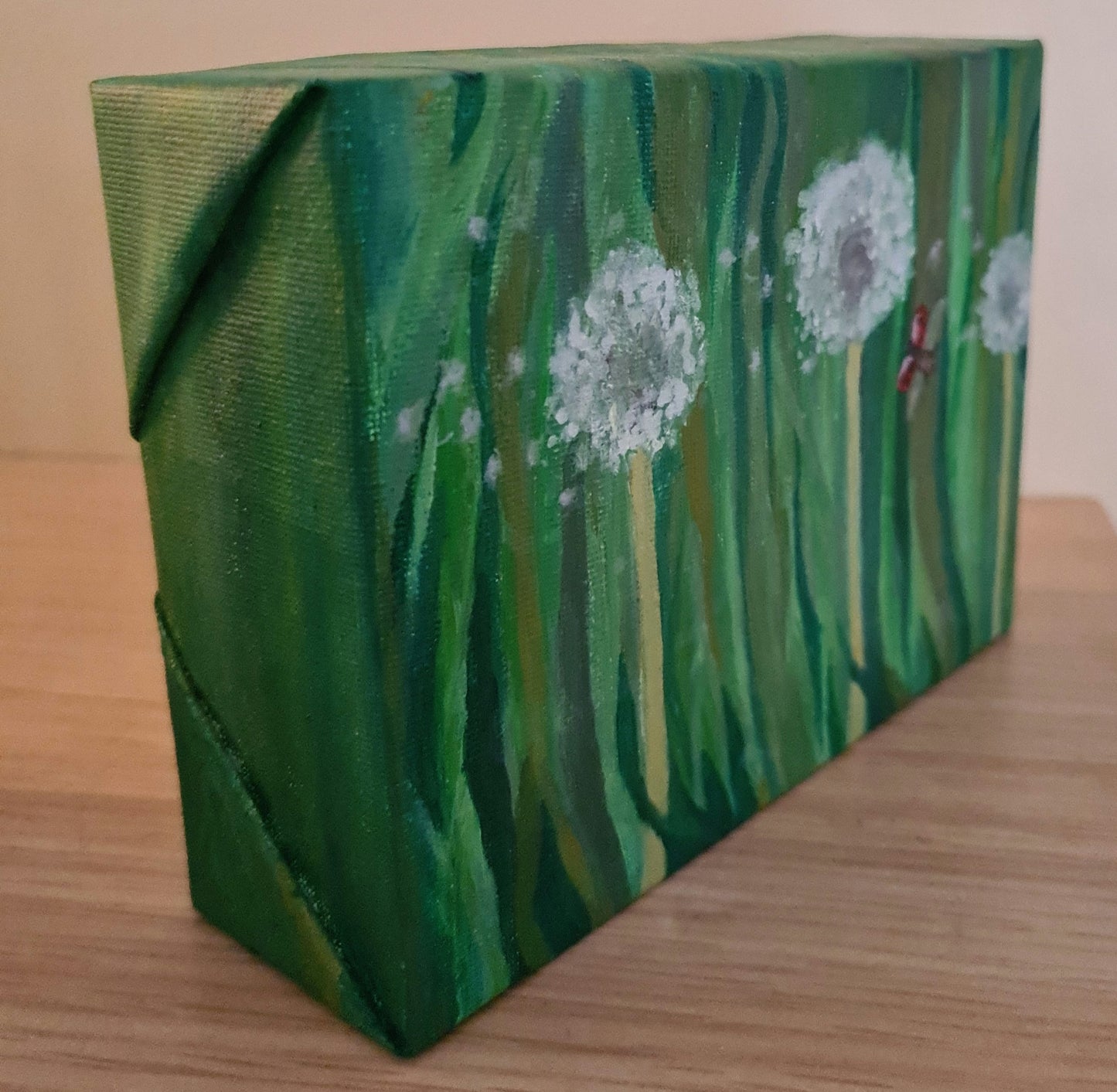 Dandelion clocks and a flying ladybird image 3