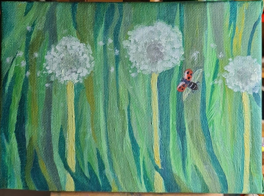 Dandelion clocks and a flying ladybird image 1