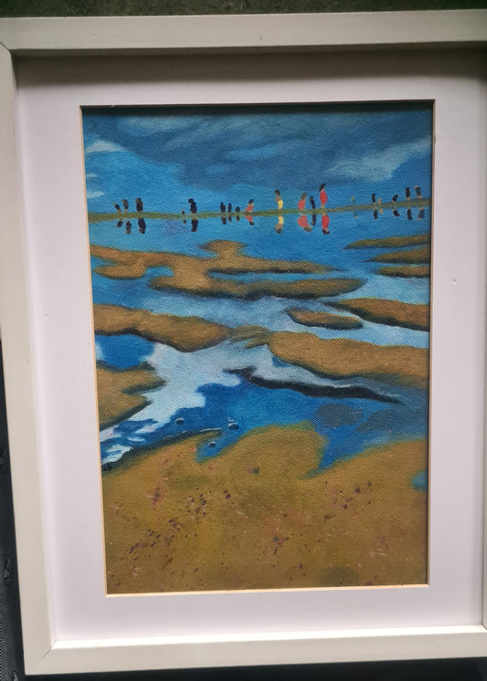 Framed abstract artwork with blue and brown patterns on a dark surface