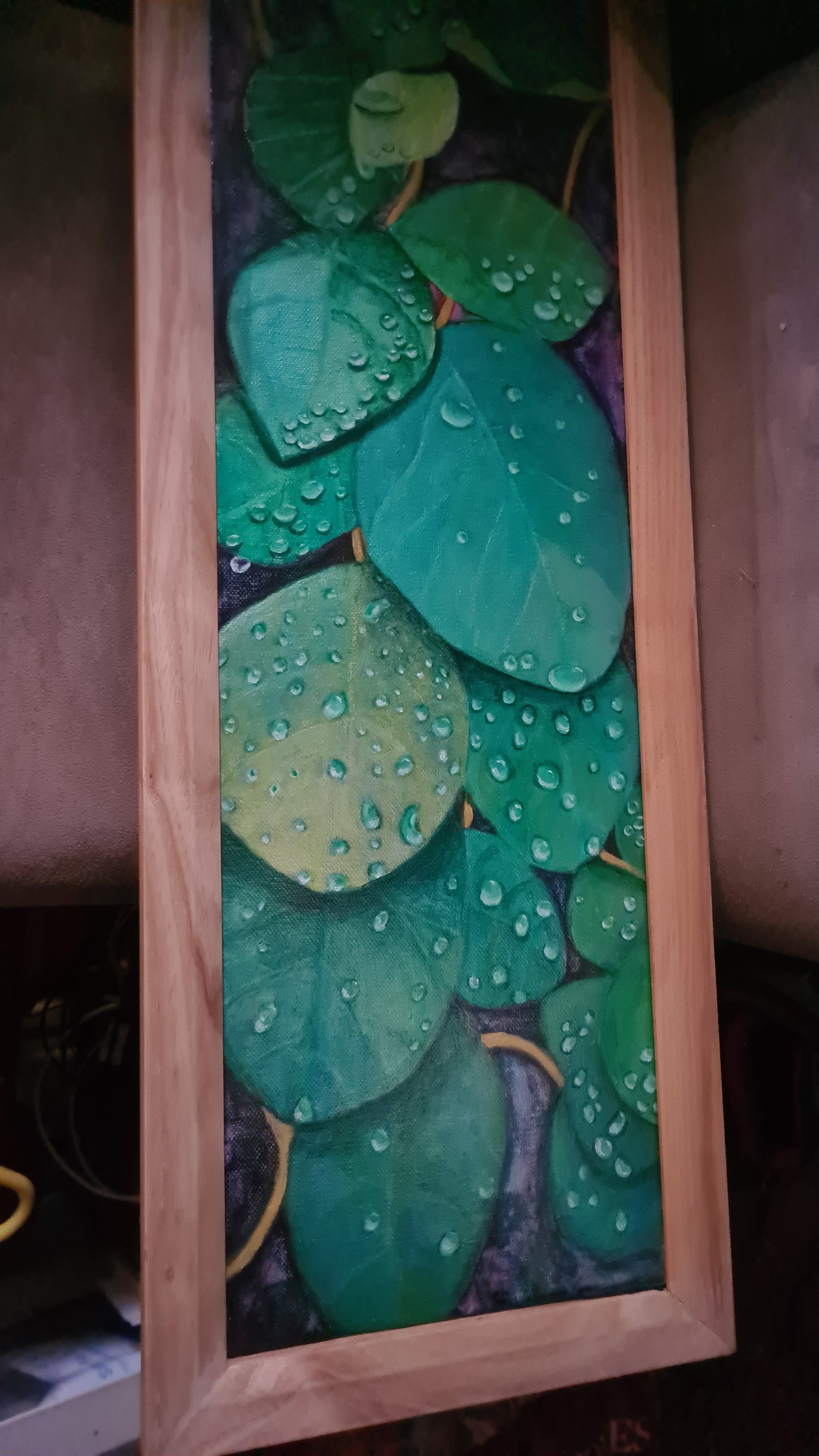 Decorative piece with green leaf pattern on a wooden frame