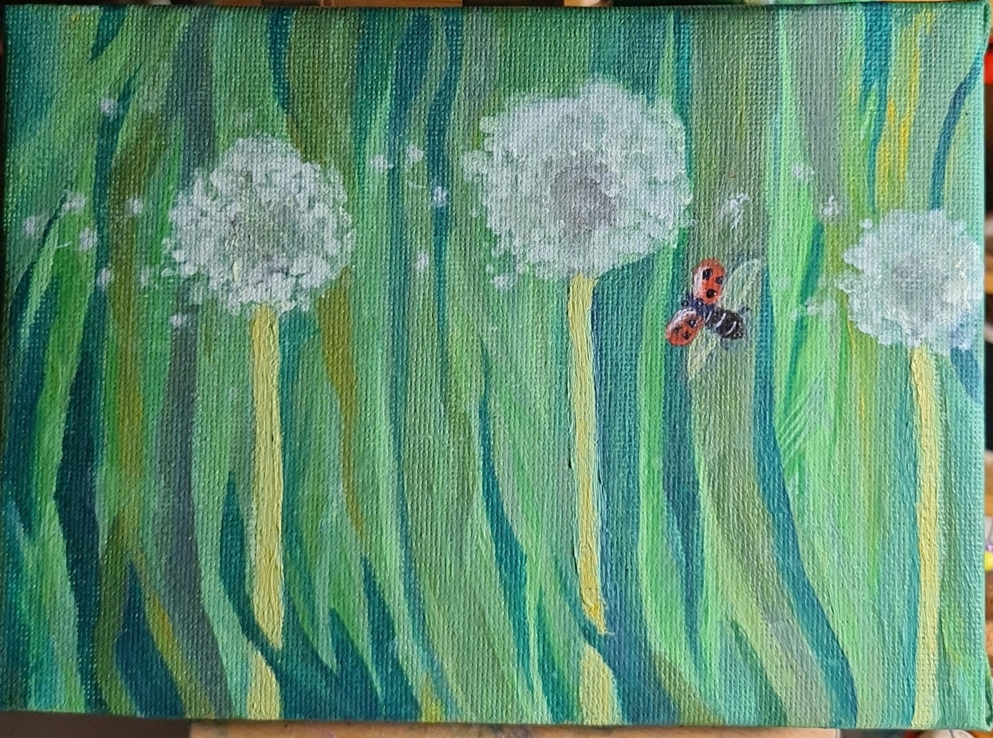 Dandelion clocks and a flying ladybird image 1